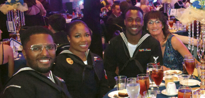 A table of seamen and their dates from Strategic Communications Wing One pose during the 250th Navy Birthday Ball, Oct 4, 2025WEB